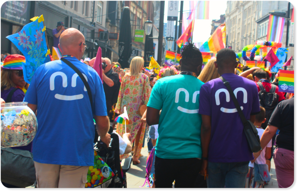 Innovate Trust employees at pride wearing t-shirts with the innovate trust smile logo