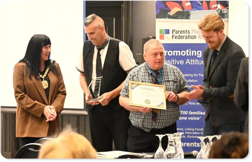 David and Darren on stage at the Understanding Disability Awards with project manager Pete, accepting the Committee award